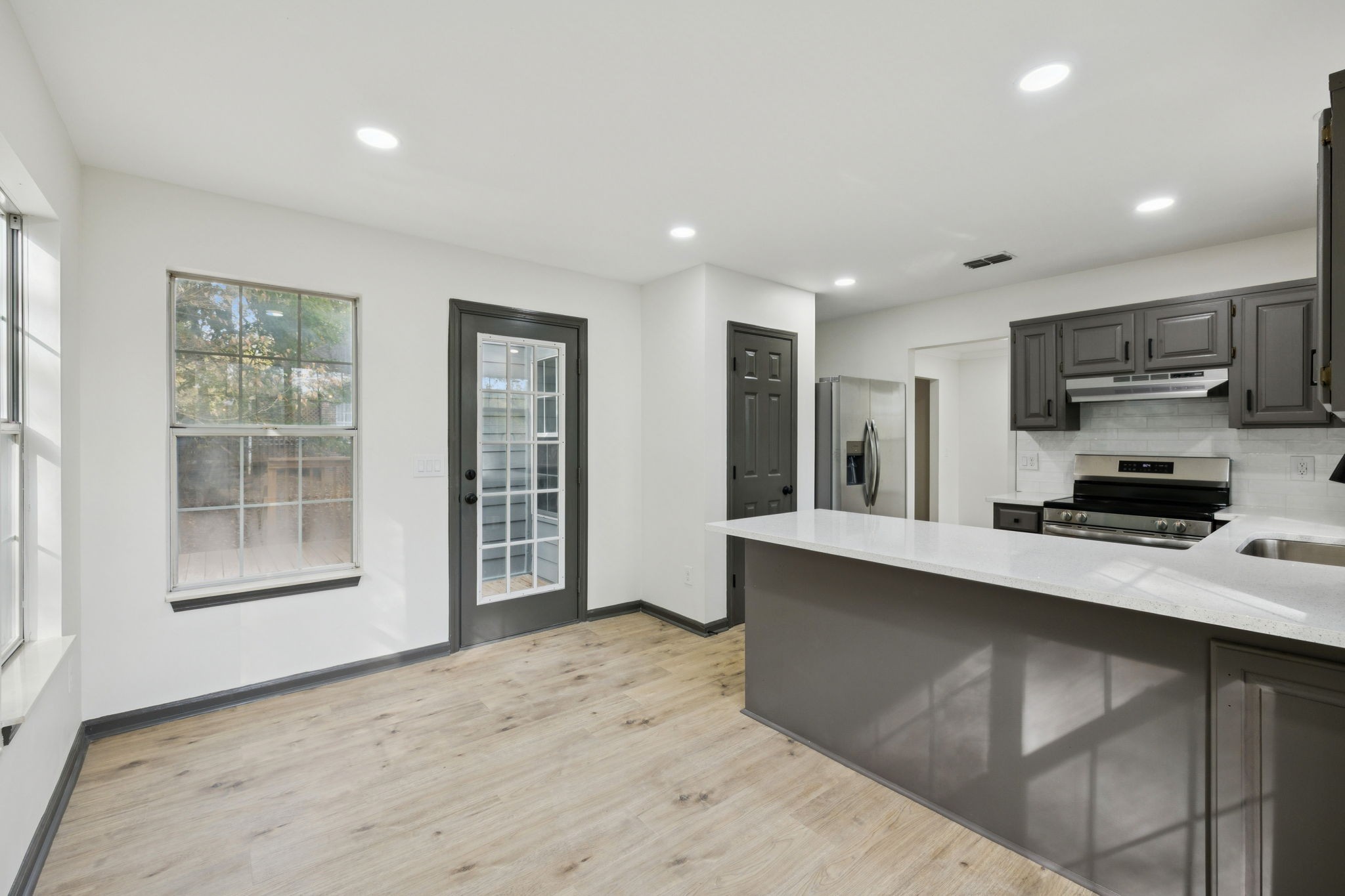 4612 Raccoon Trail Hermitage, TN 37076 - Photo 17 of 36 a kitchen with stainless steel appliances a sink stove and cabinets