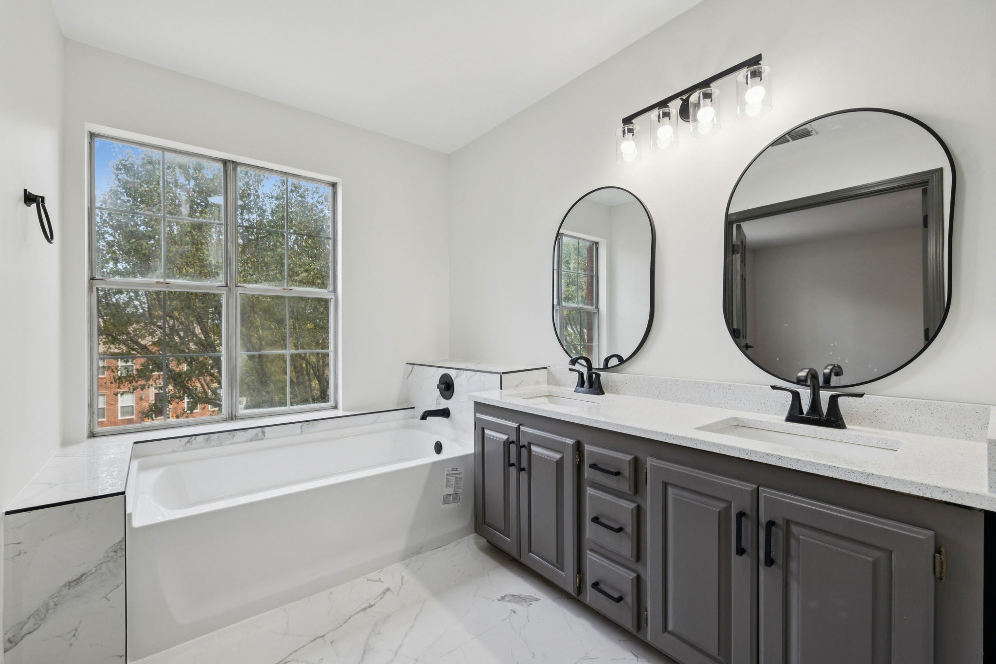 4612 Raccoon Trail Hermitage, TN 37076 - Photo 21 of 36 a bathroom with a double vanity sink and a mirror