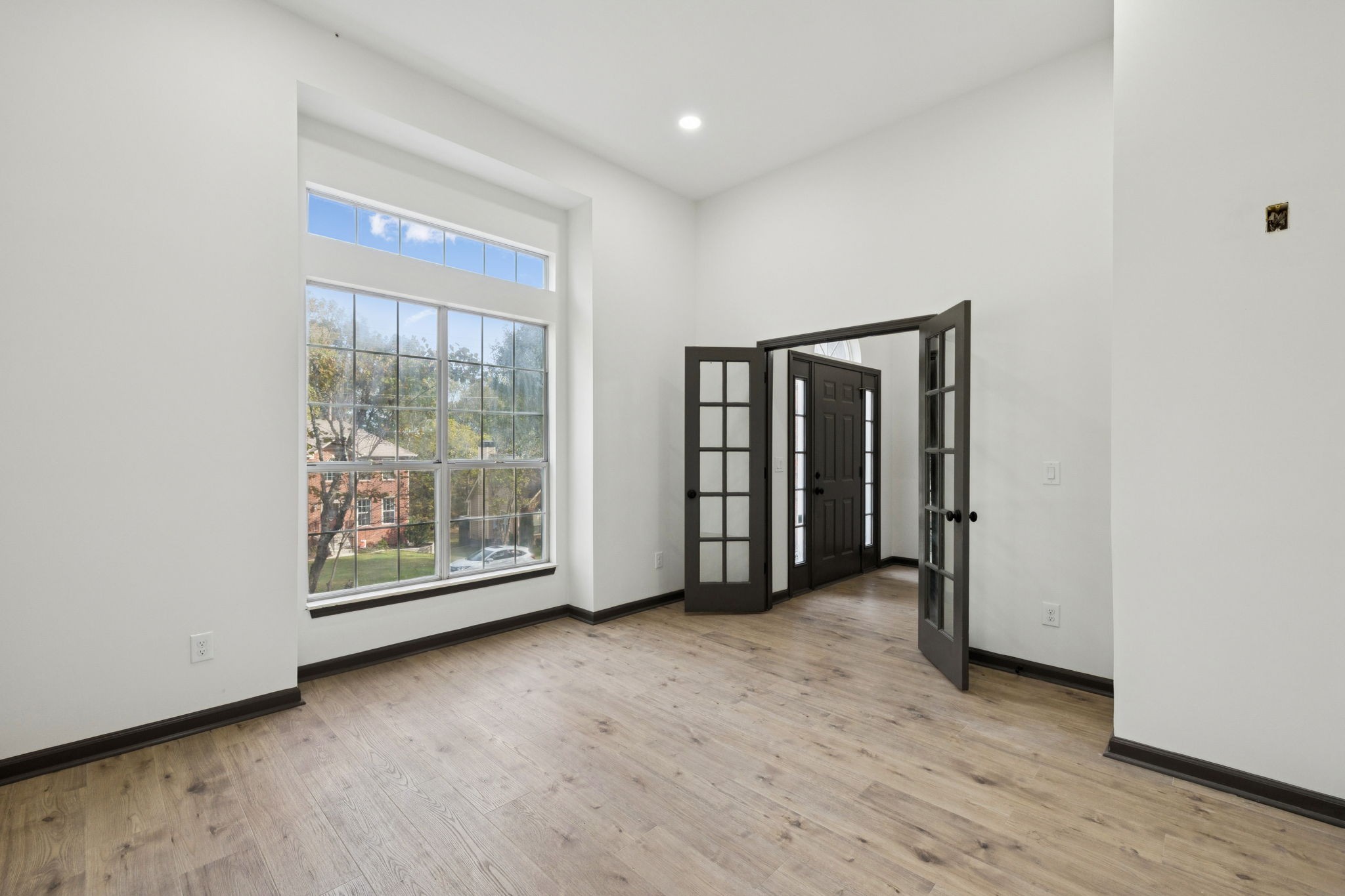 4612 Raccoon Trail Hermitage, TN 37076 - Photo 5 of 36 an empty room with wooden floor and windows
