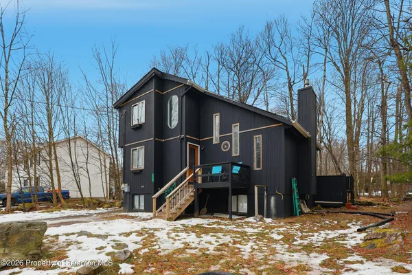 a view of a house with a snow in the yard