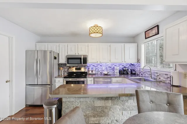 a kitchen with a refrigerator a stove a sink and a counter space