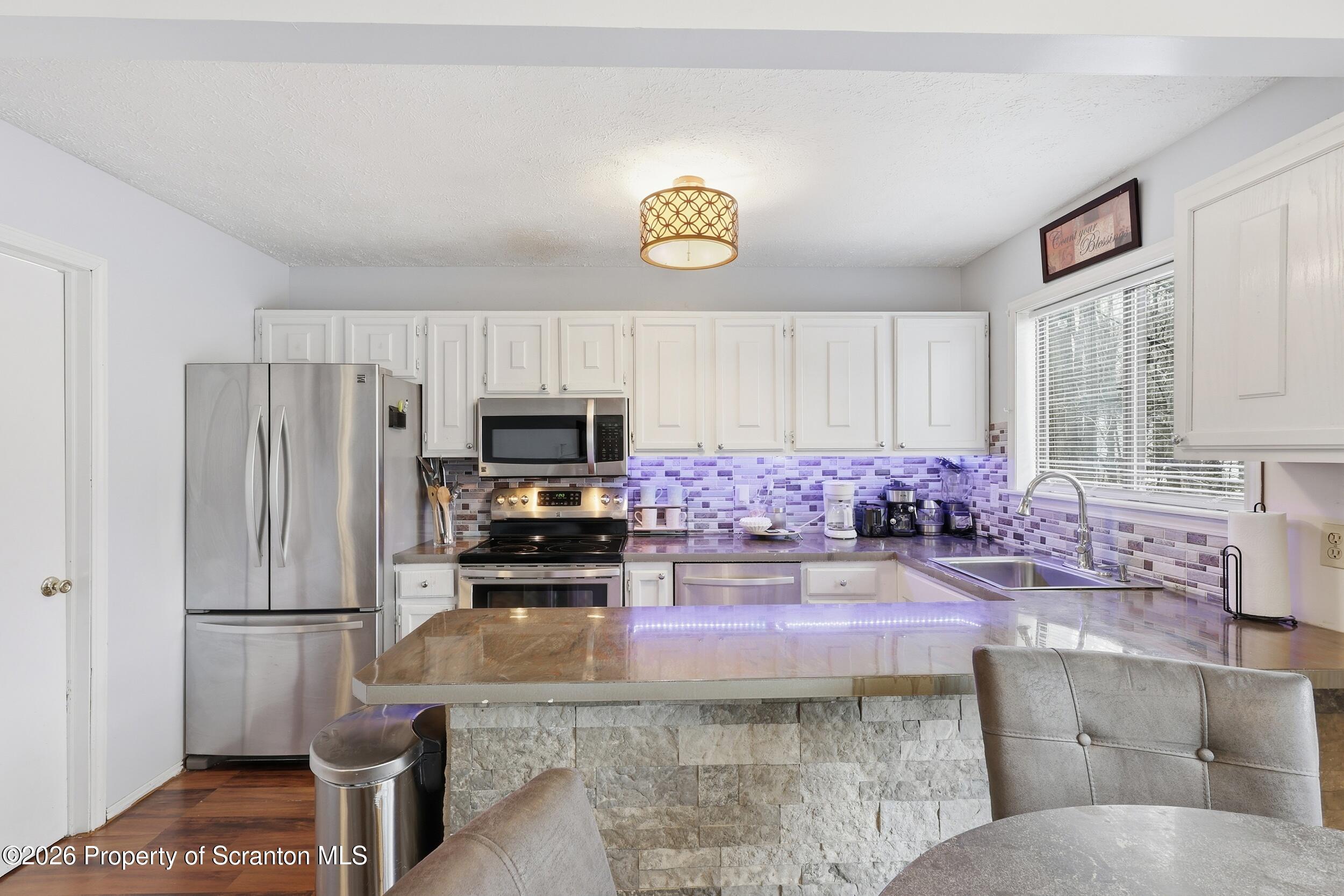 1379 Winding Way Tobyhanna, PA 18466 - Photo 12 of 51 a kitchen with a refrigerator a stove a sink and a counter space
