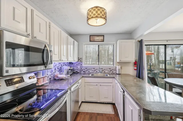 a kitchen with a stove a sink and a microwave