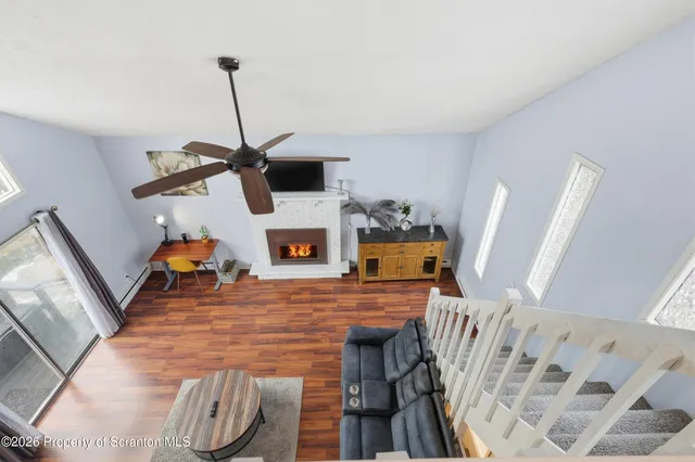 a living room with furniture and a wooden floor