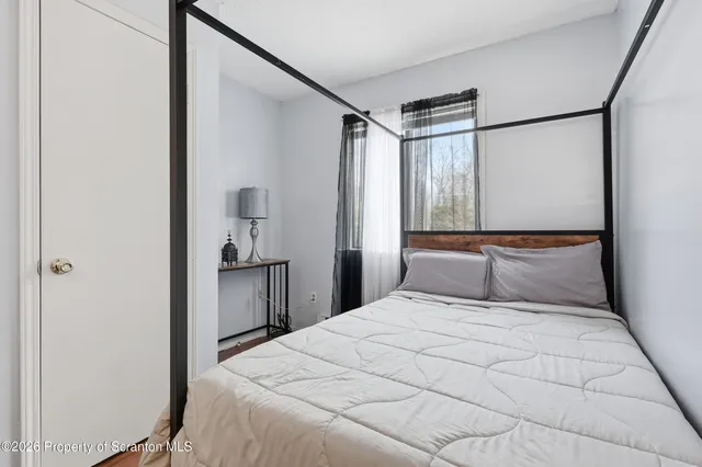 a bedroom with a large bed and a chandelier