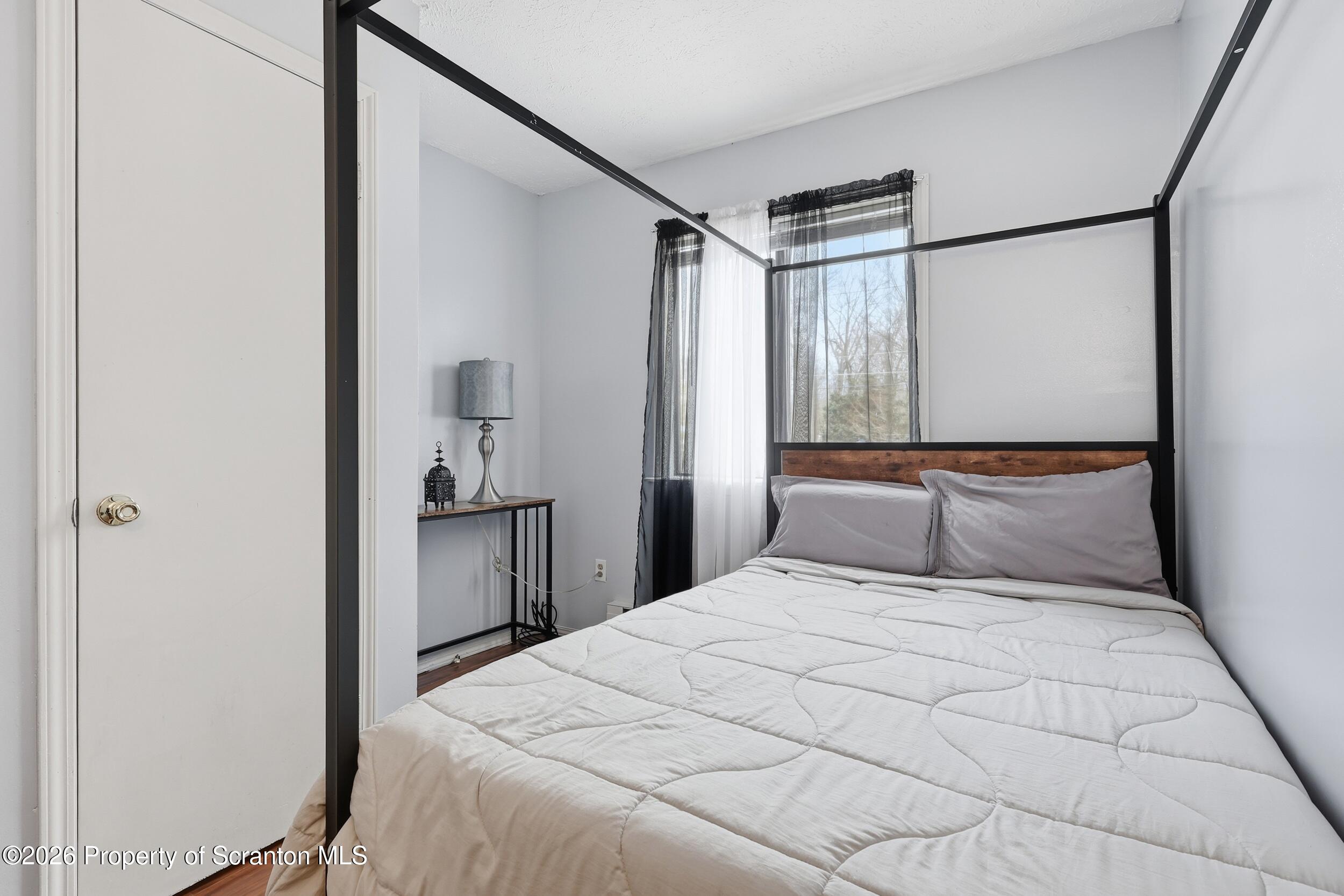 1379 Winding Way Tobyhanna, PA 18466 - Photo 21 of 51 a bedroom with a large bed and a chandelier