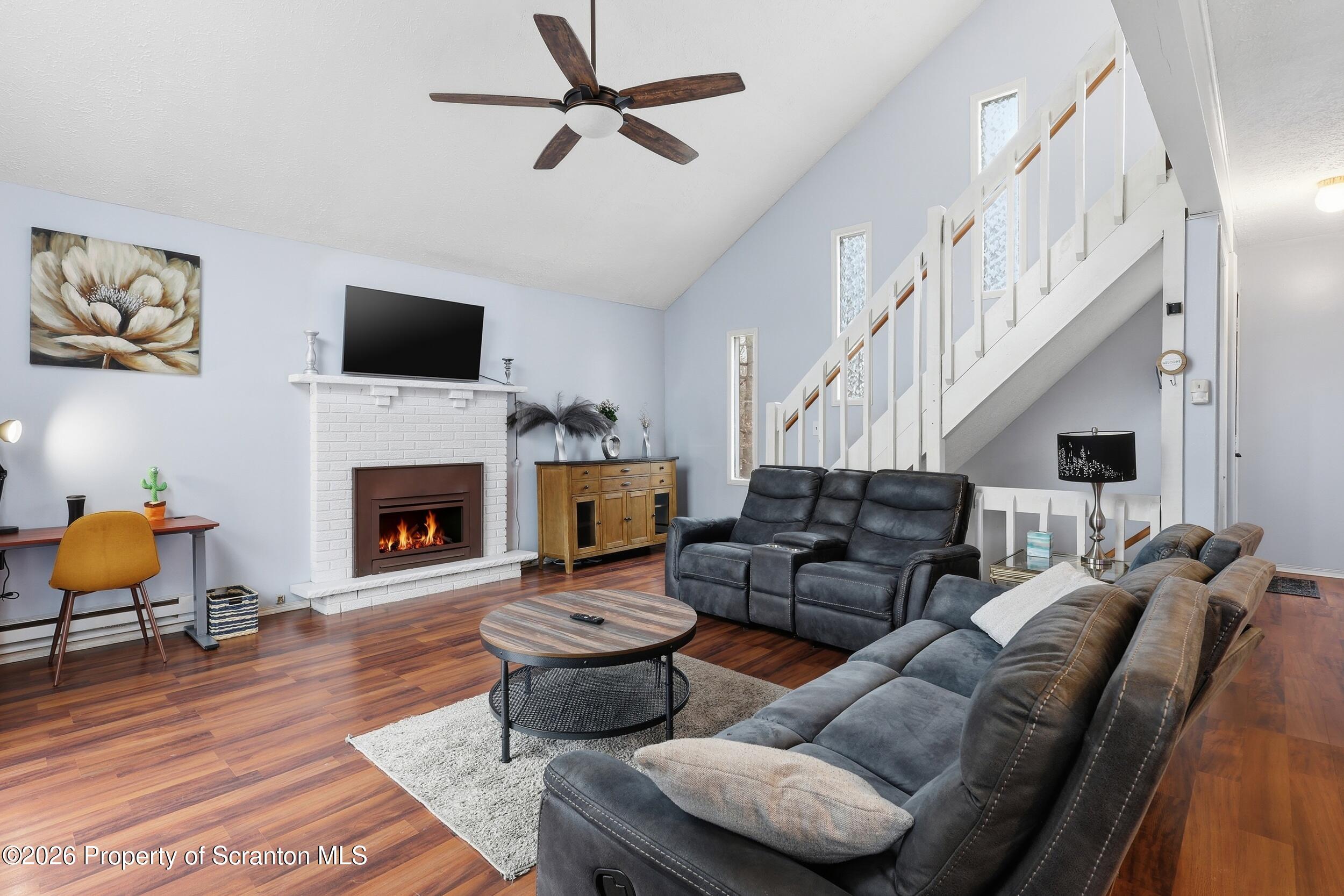 1379 Winding Way Tobyhanna, PA 18466 - Photo 8 of 51 a living room with furniture a flat screen tv and a fireplace