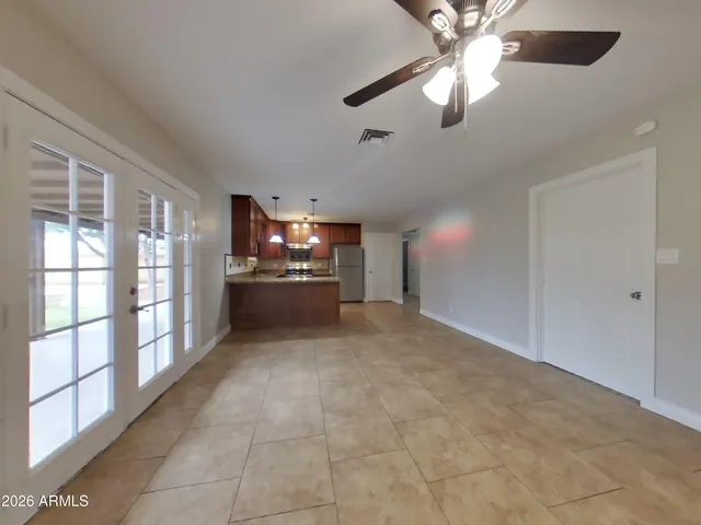 a view of an empty room with a ceiling fan