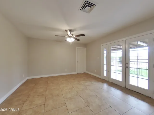 a view of a livingroom with a ceiling fan and window
