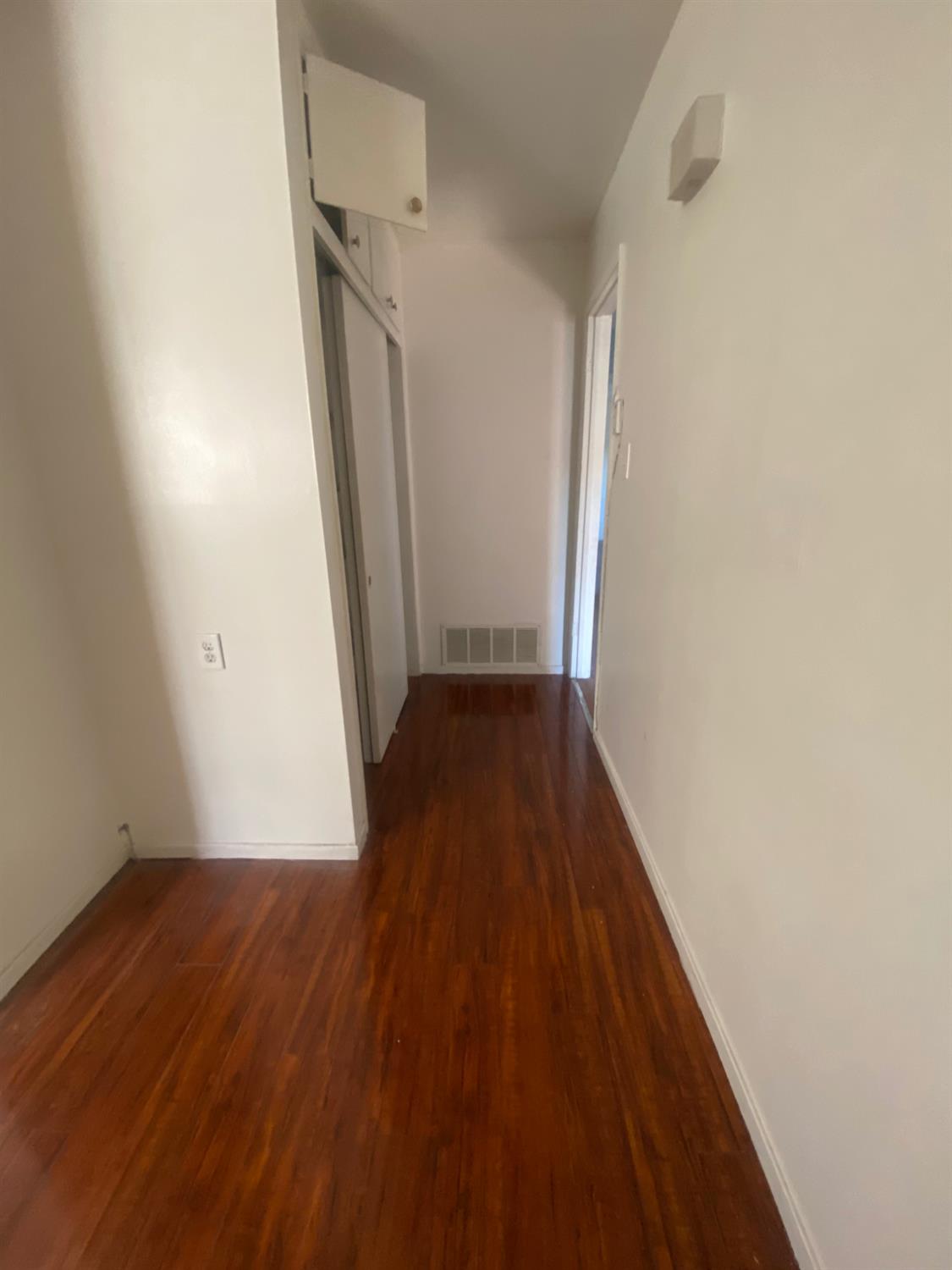 333 East Linden Avenue Reedley, CA 93654 - Photo 15 of 21 a view of a hallway with wooden floor and staircase