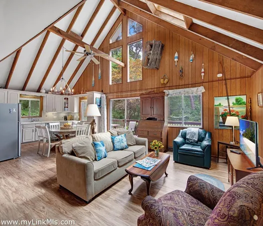 a living room with furniture a fireplace and a table