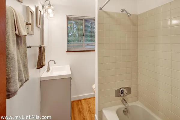 a bathroom with a sink a granite tub and shower