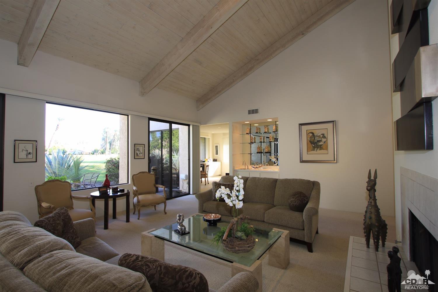 927 Inverness Drive Rancho Mirage, CA 92270 - Photo 1 of 42 a living room with furniture a flat screen tv and a fireplace