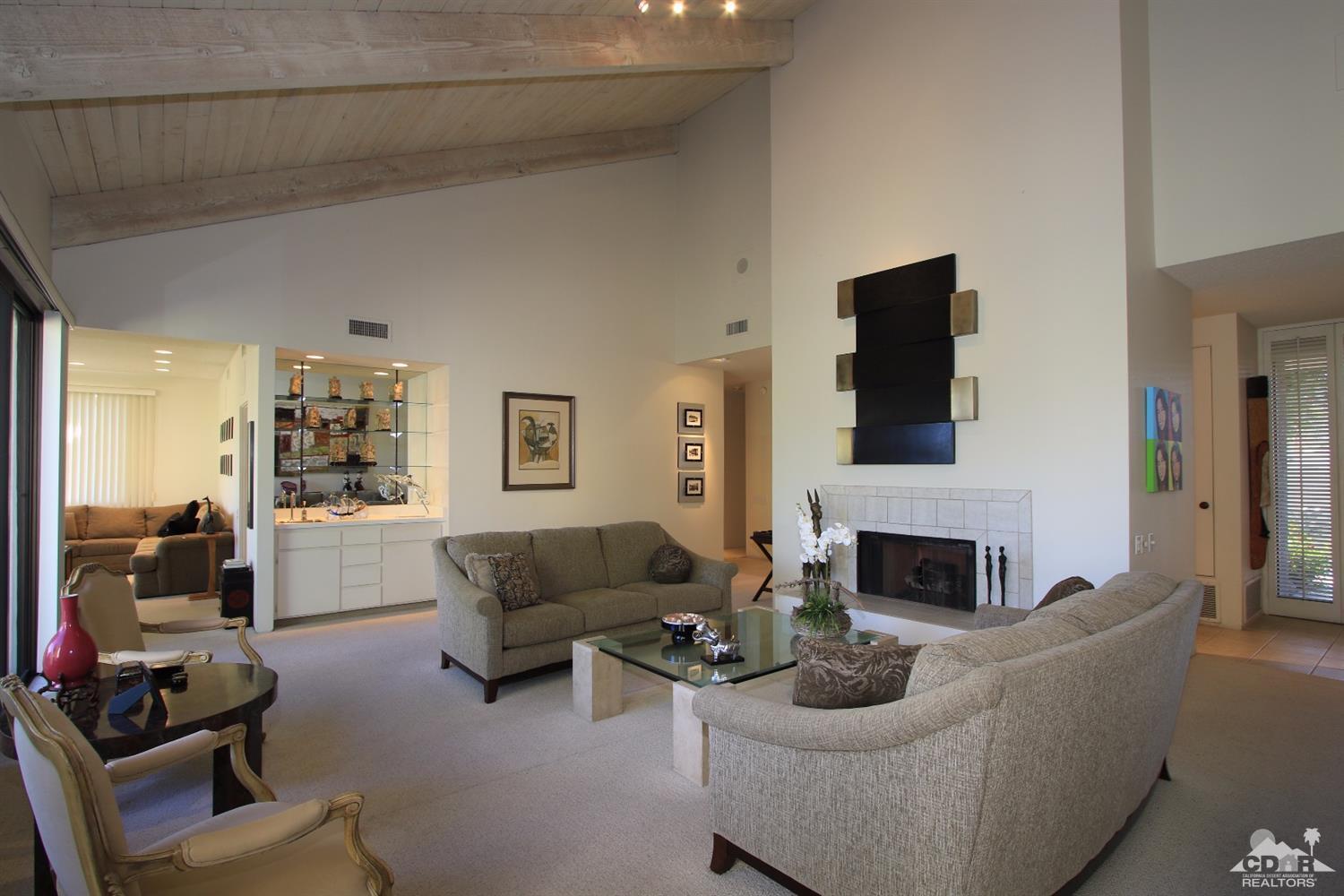 927 Inverness Drive Rancho Mirage, CA 92270 - Photo 3 of 42 a living room with furniture a fireplace and a flat screen tv