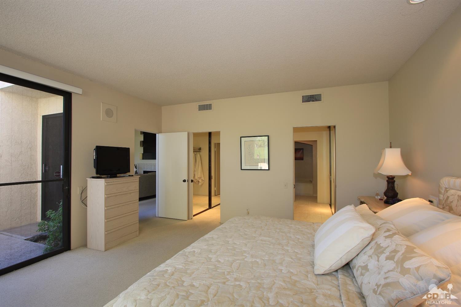 927 Inverness Drive Rancho Mirage, CA 92270 - Photo 22 of 42 a bedroom with a bed and a television