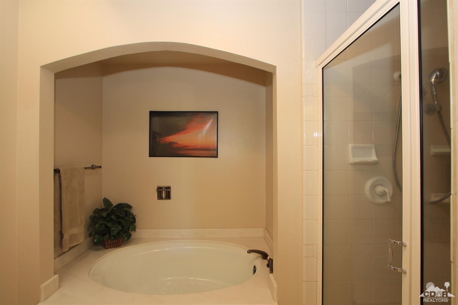 927 Inverness Drive Rancho Mirage, CA 92270 - Photo 23 of 42 a bathroom with a tub sink and mirror