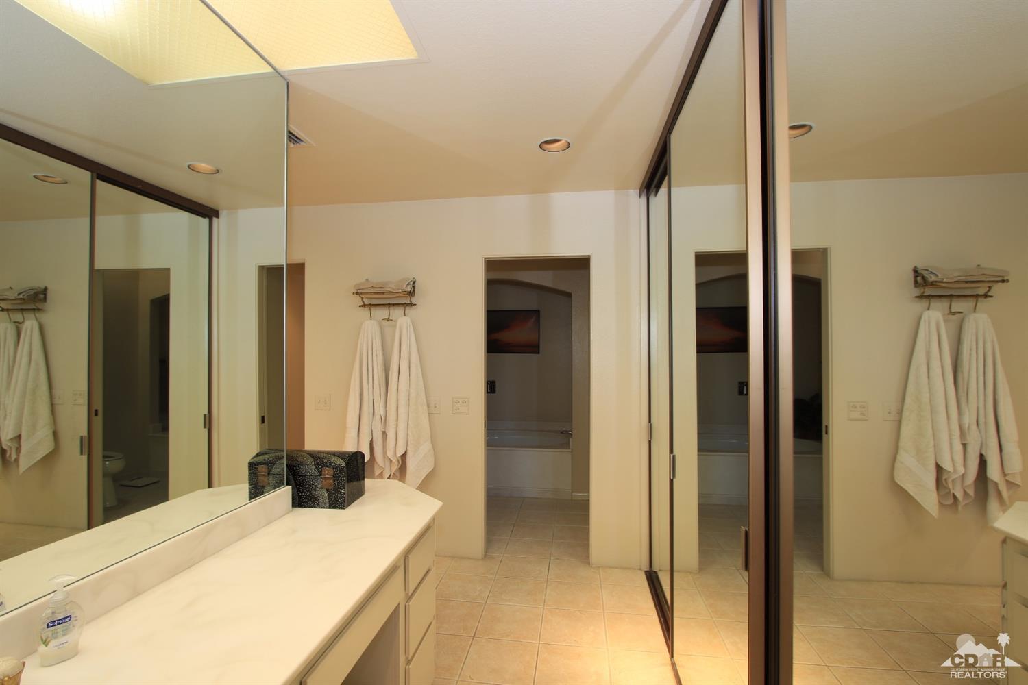 927 Inverness Drive Rancho Mirage, CA 92270 - Photo 24 of 42 a bedroom with a bed and a mirror