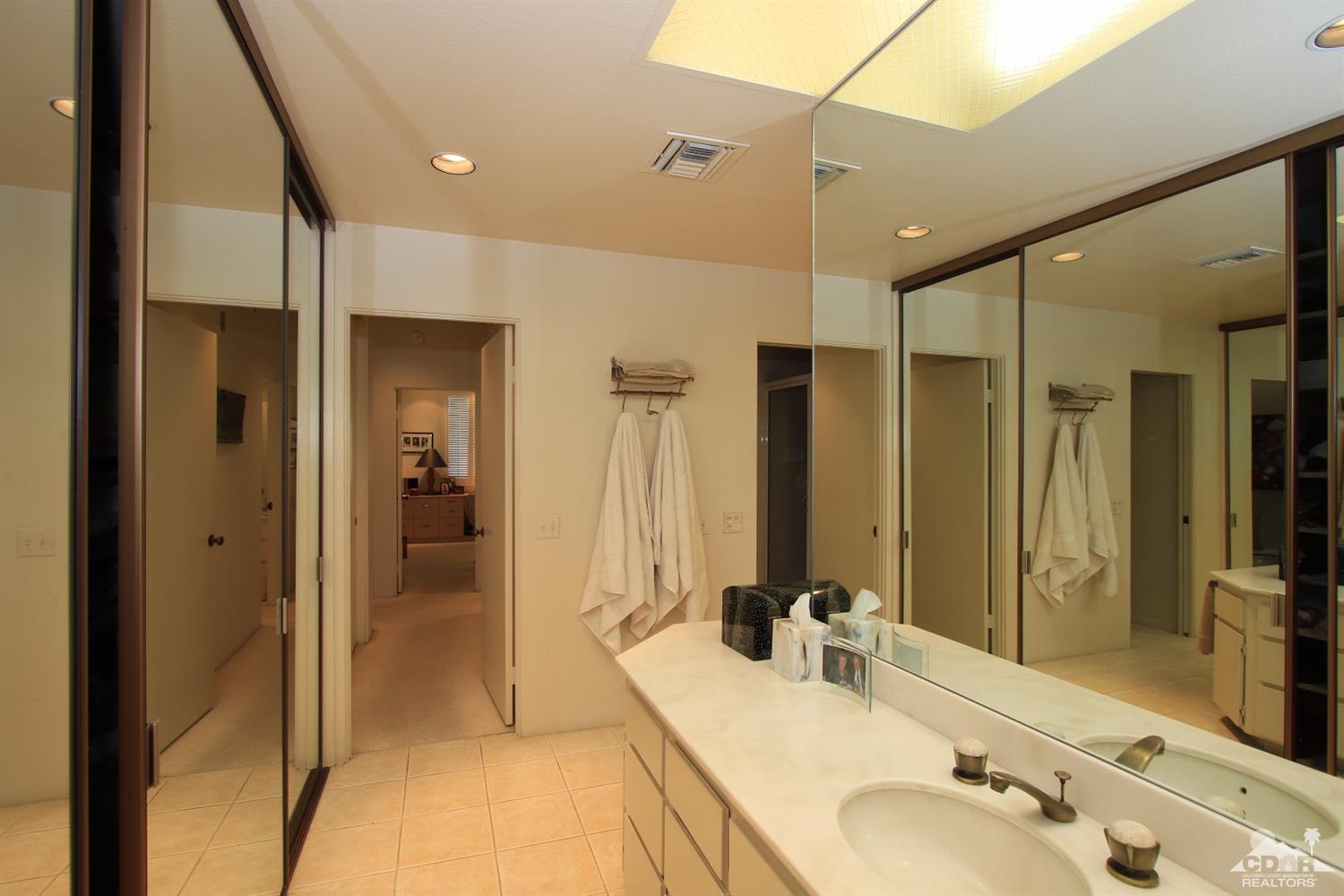 927 Inverness Drive Rancho Mirage, CA 92270 - Photo 25 of 42 a bathroom with a tub sink shower and mirror
