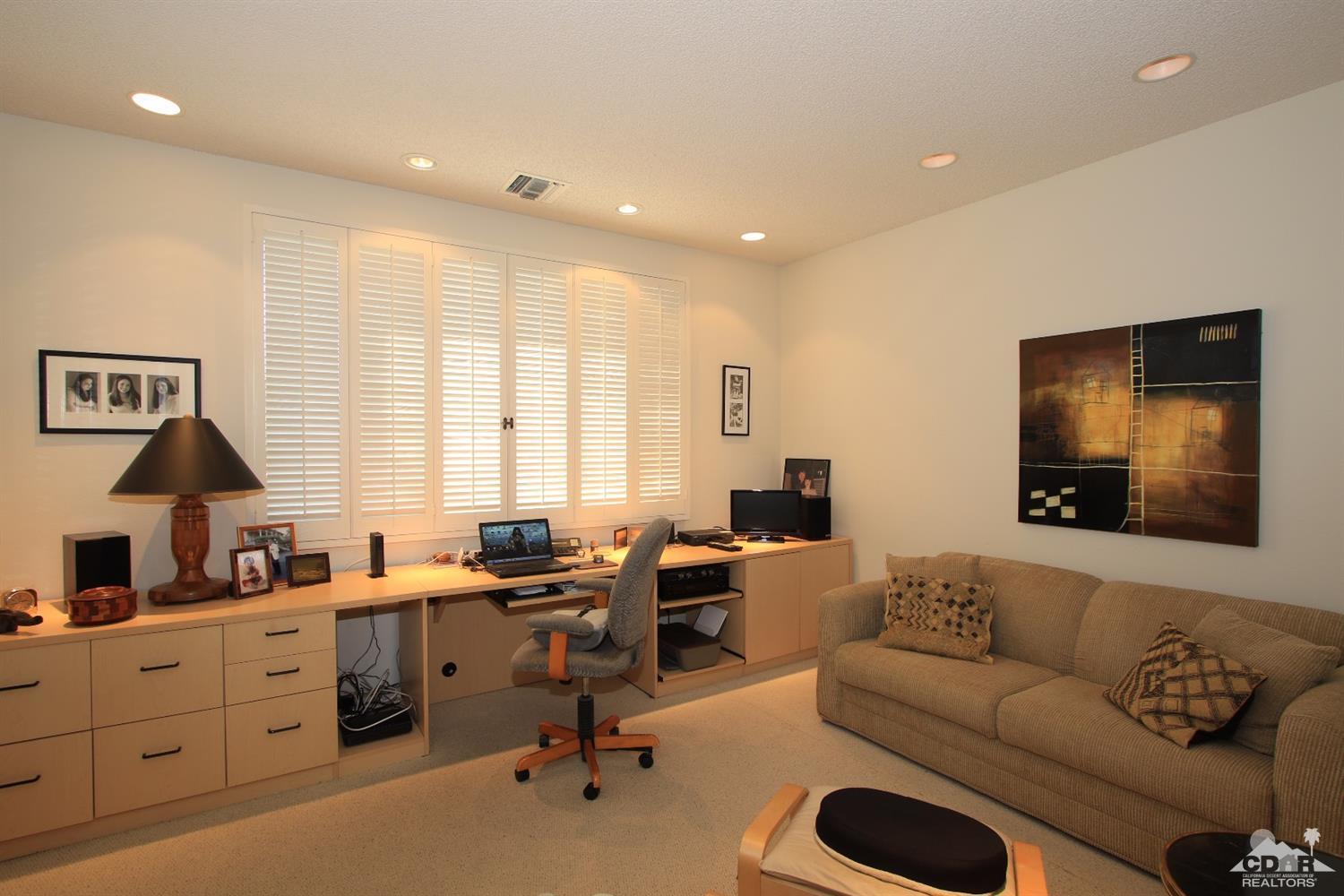 927 Inverness Drive Rancho Mirage, CA 92270 - Photo 26 of 42 a living room with furniture and a flat screen tv