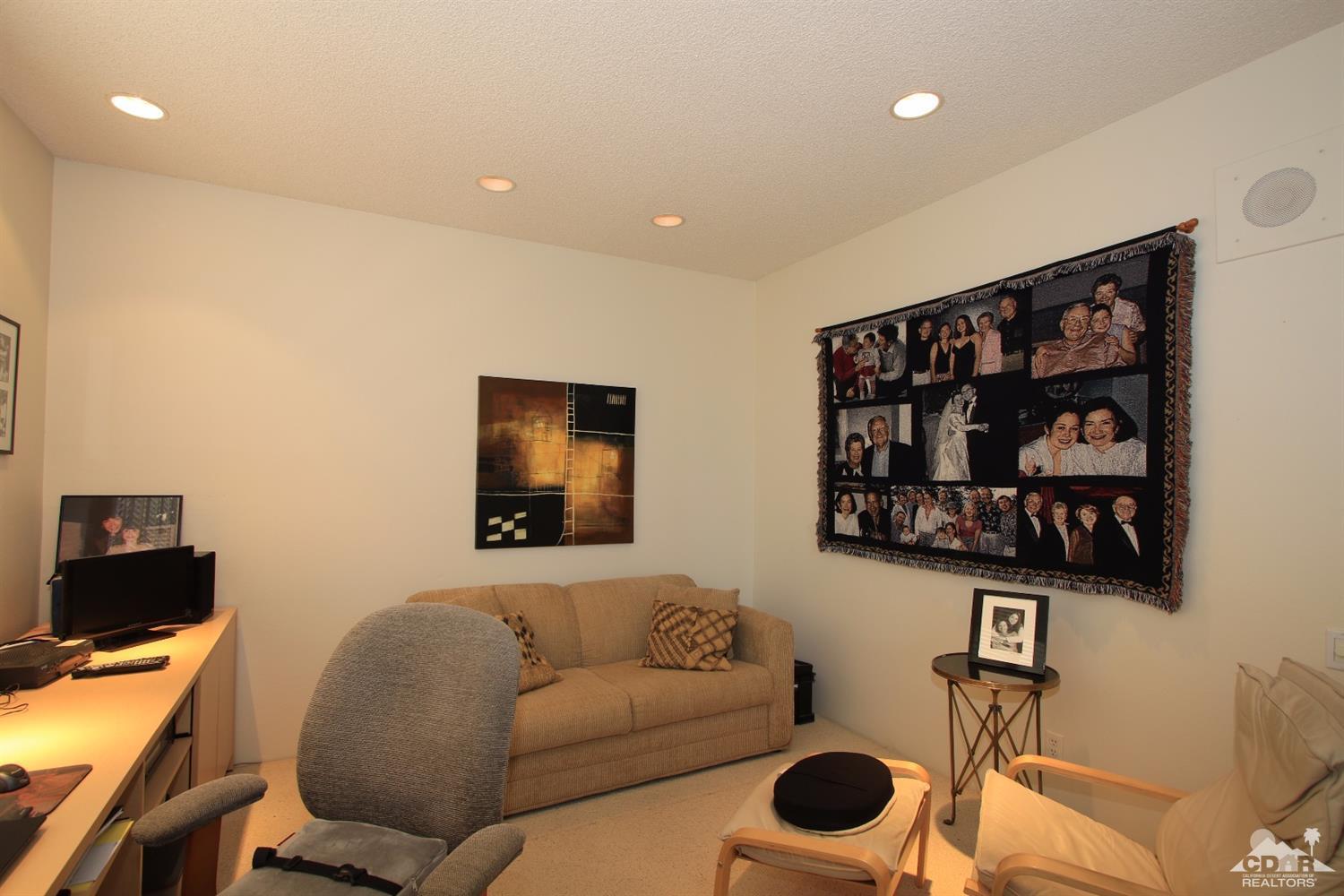 927 Inverness Drive Rancho Mirage, CA 92270 - Photo 27 of 42 a living room with furniture and wall paintings