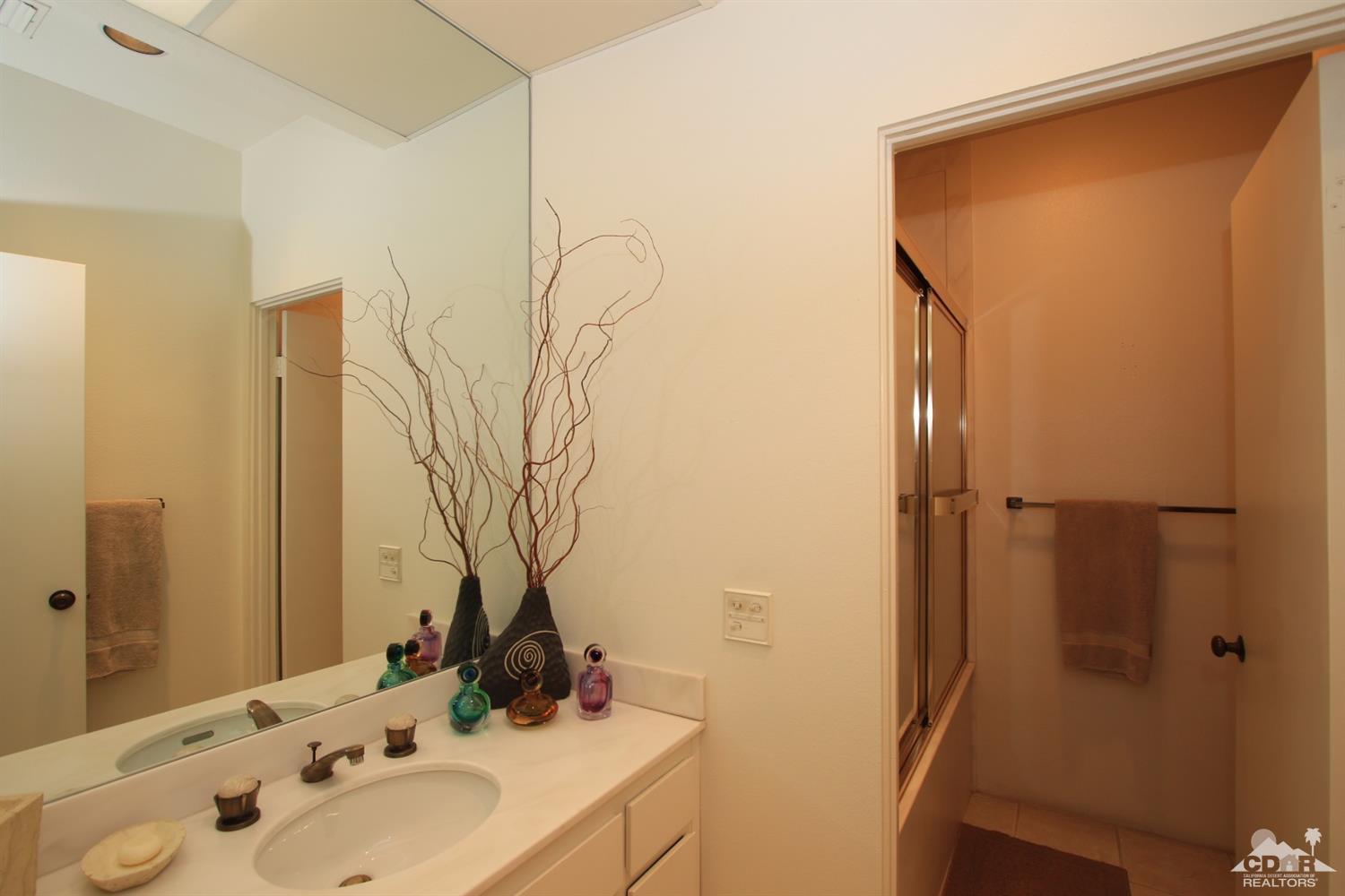 927 Inverness Drive Rancho Mirage, CA 92270 - Photo 28 of 42 a bathroom with a sink and a mirror