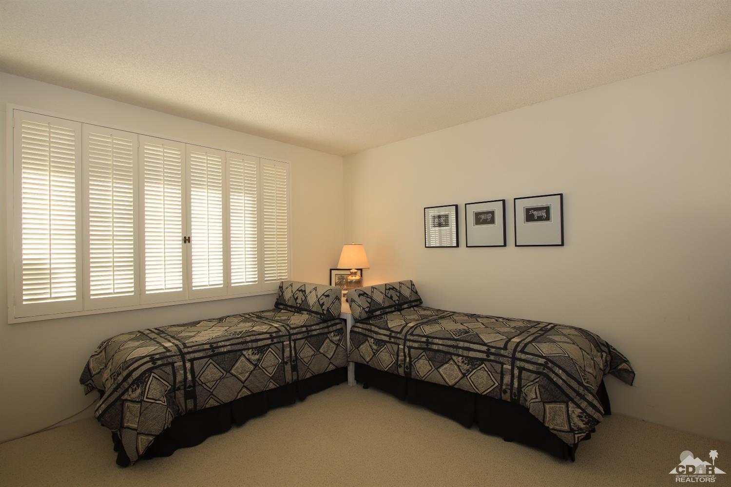 927 Inverness Drive Rancho Mirage, CA 92270 - Photo 29 of 42 a bedroom with two beds and a couch