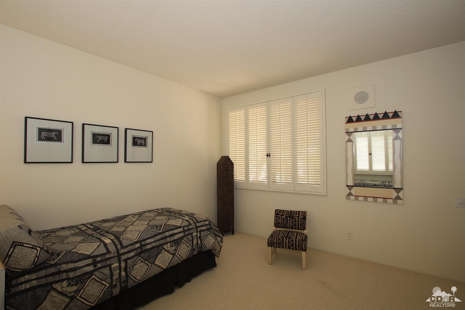 927 Inverness Drive Rancho Mirage, CA 92270 - Photo 30 of 42 a bedroom with a bed and a window