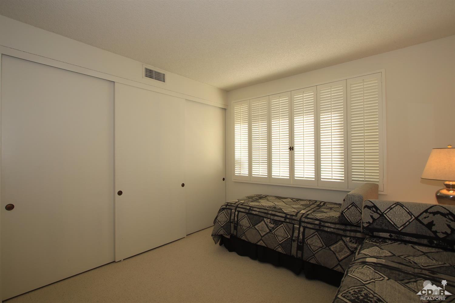 927 Inverness Drive Rancho Mirage, CA 92270 - Photo 31 of 42 a bed room with a bed and a couch