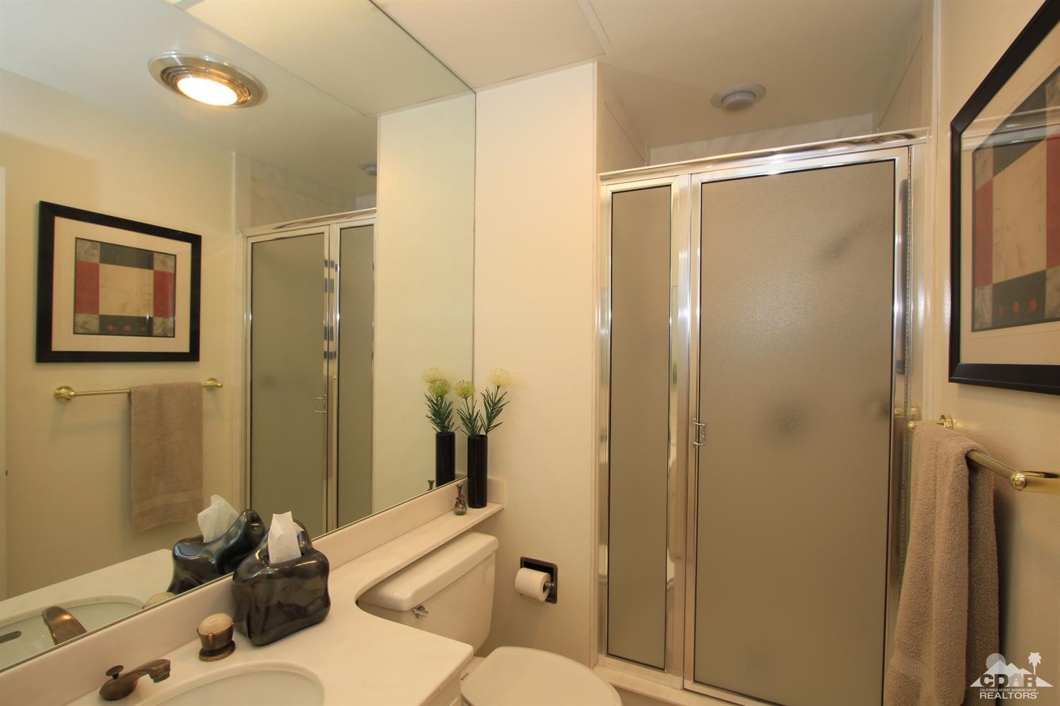 927 Inverness Drive Rancho Mirage, CA 92270 - Photo 32 of 42 a bathroom with a sink mirror vanity and toilet