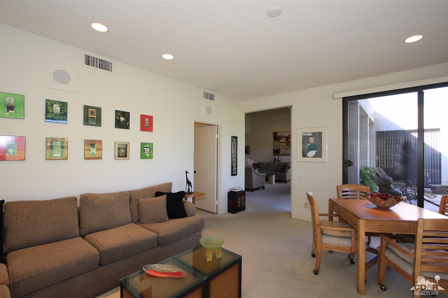 927 Inverness Drive Rancho Mirage, CA 92270 - Photo 6 of 42 a living room with furniture a table and a flat screen tv