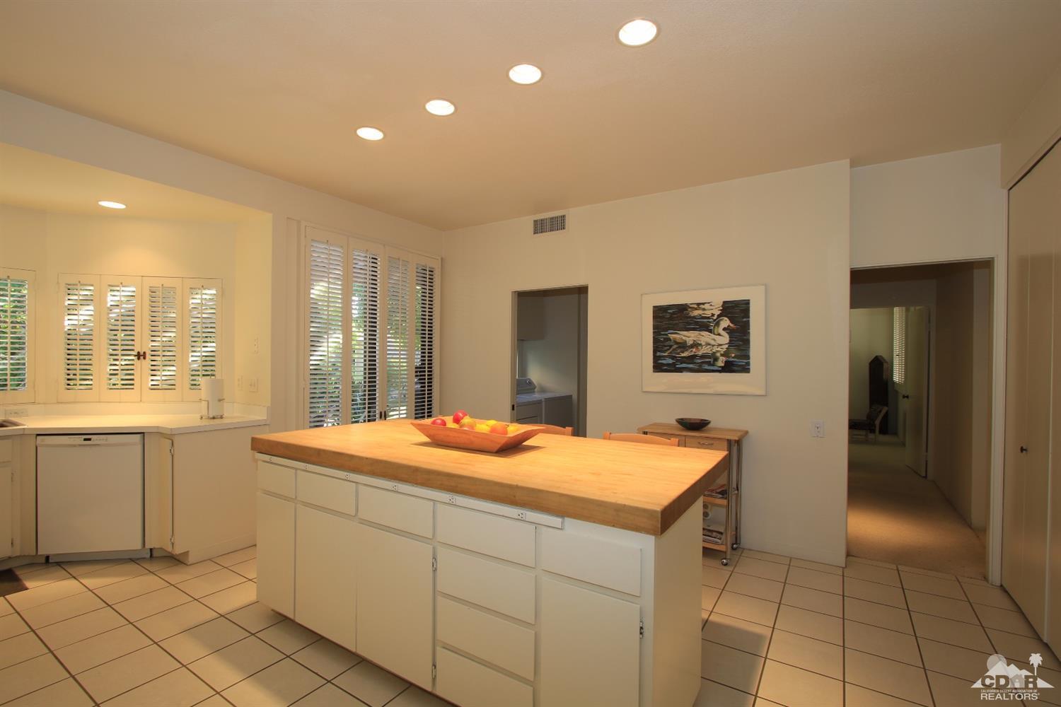 927 Inverness Drive Rancho Mirage, CA 92270 - Photo 8 of 42 a dining hall with stainless steel appliances granite countertop a sink and cabinets