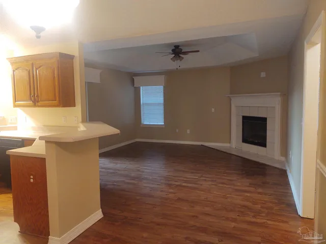 a view of a kitchen cabinets a sink and wooden floor