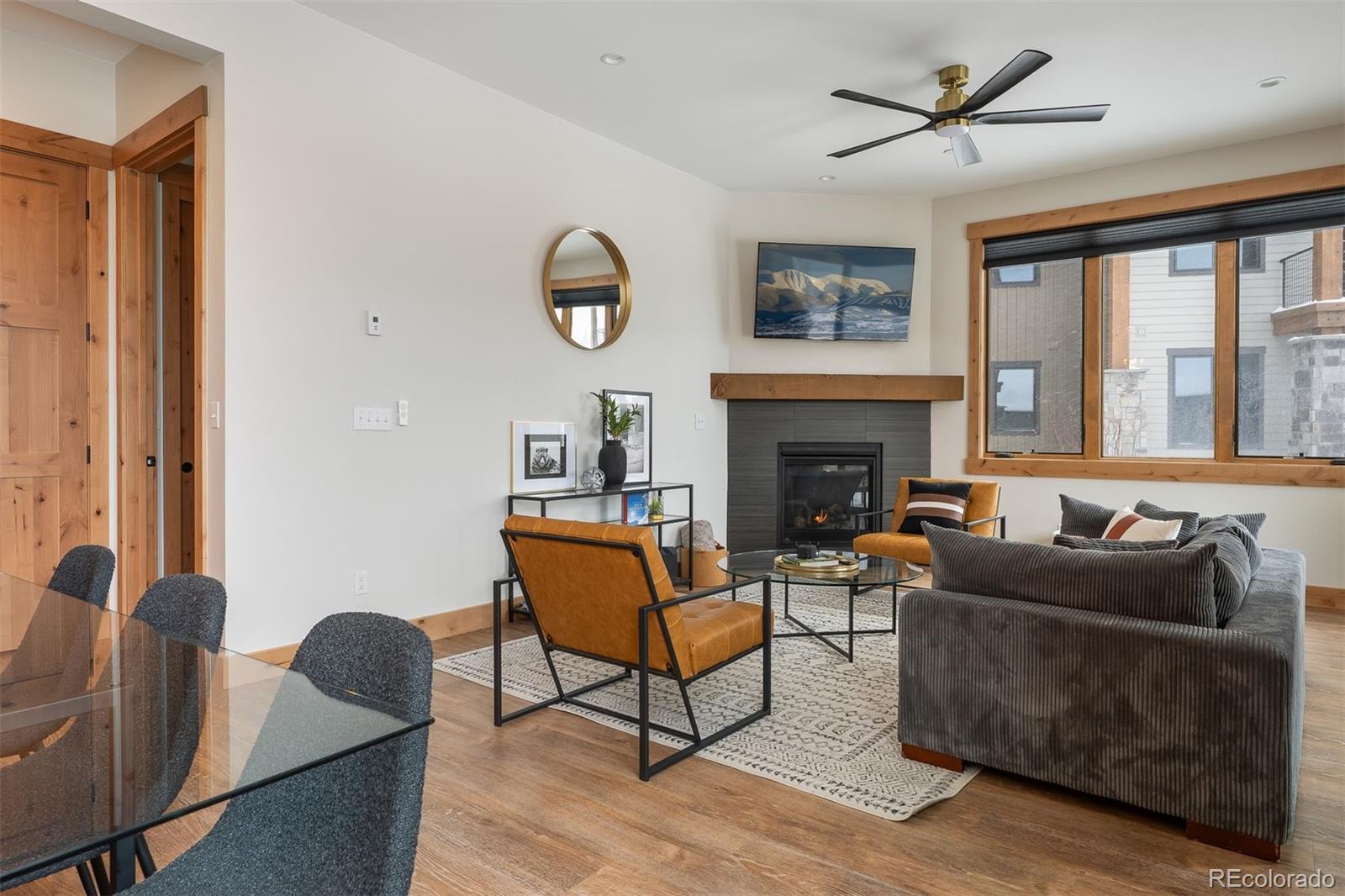 72 Meadow Trail, Unit F102 Fraser, CO 80442 - Photo 11 of 35 a living room with furniture a large window and a fireplace