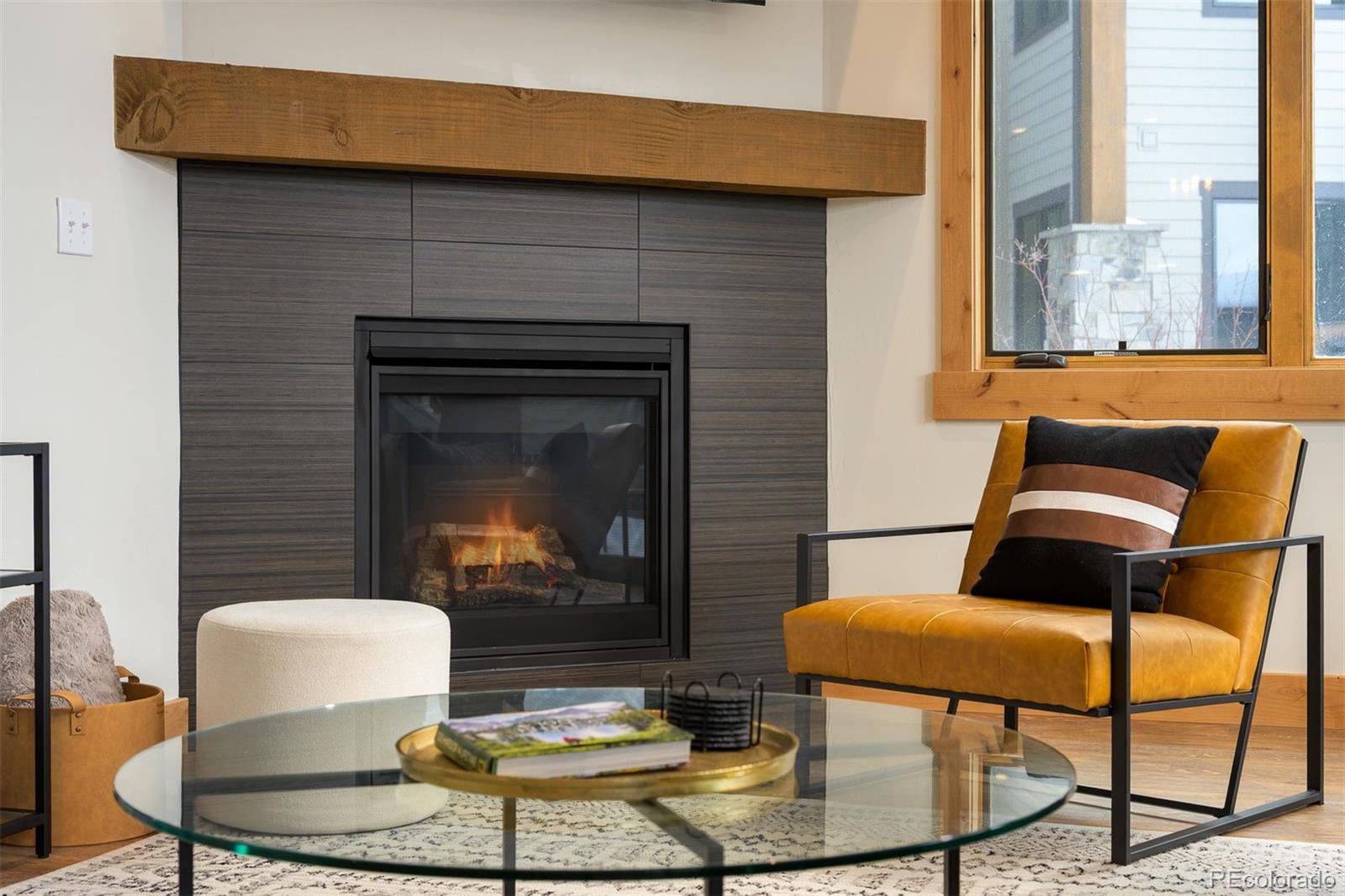 72 Meadow Trail, Unit F102 Fraser, CO 80442 - Photo 15 of 35 a living room with furniture and a fireplace