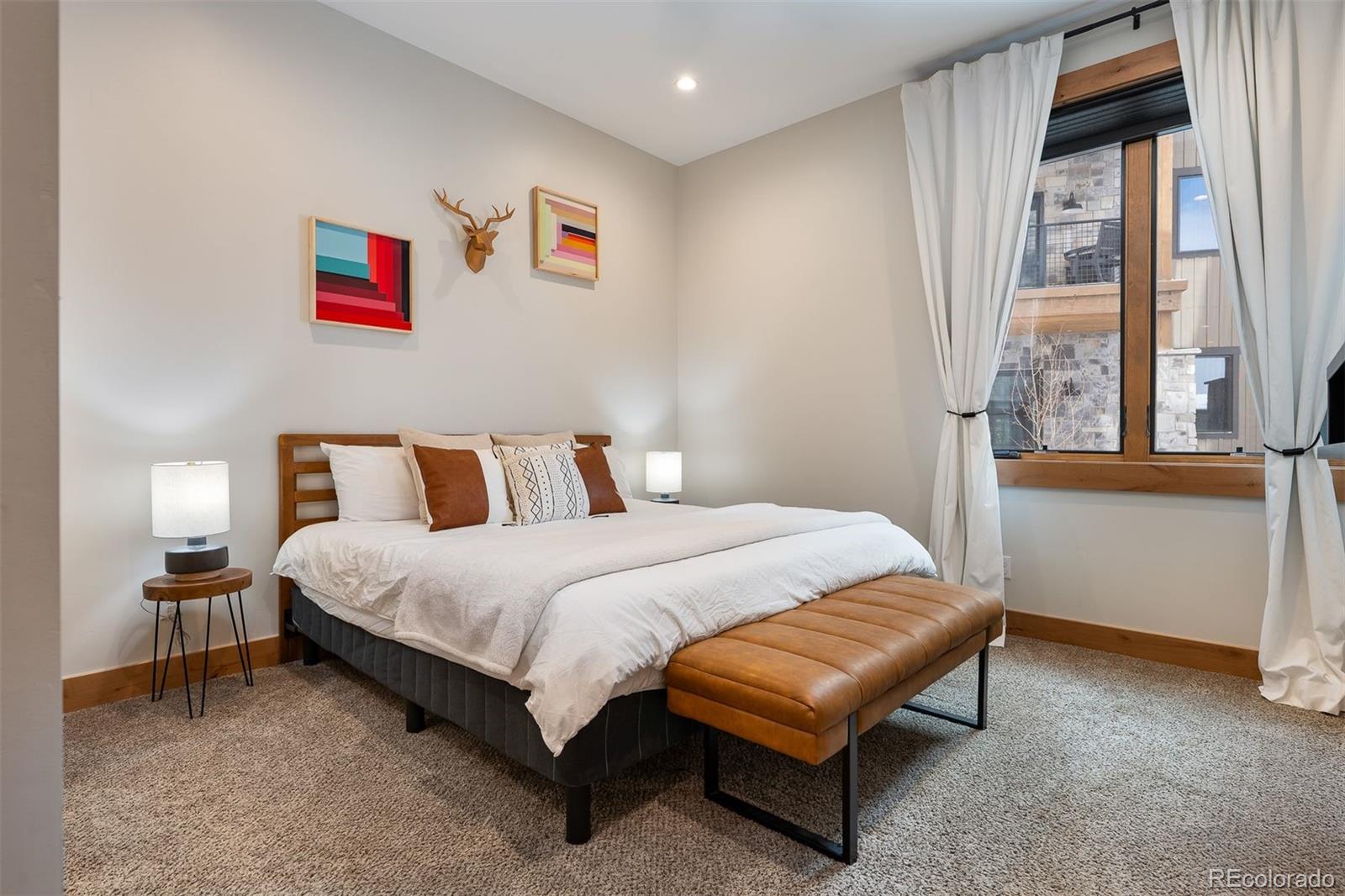 72 Meadow Trail, Unit F102 Fraser, CO 80442 - Photo 16 of 35 a bedroom with a bed and window