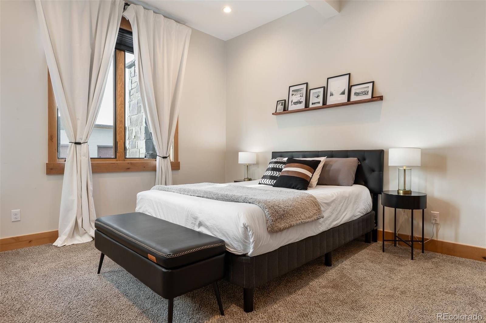 72 Meadow Trail, Unit F102 Fraser, CO 80442 - Photo 21 of 35 a bedroom with a bed and window