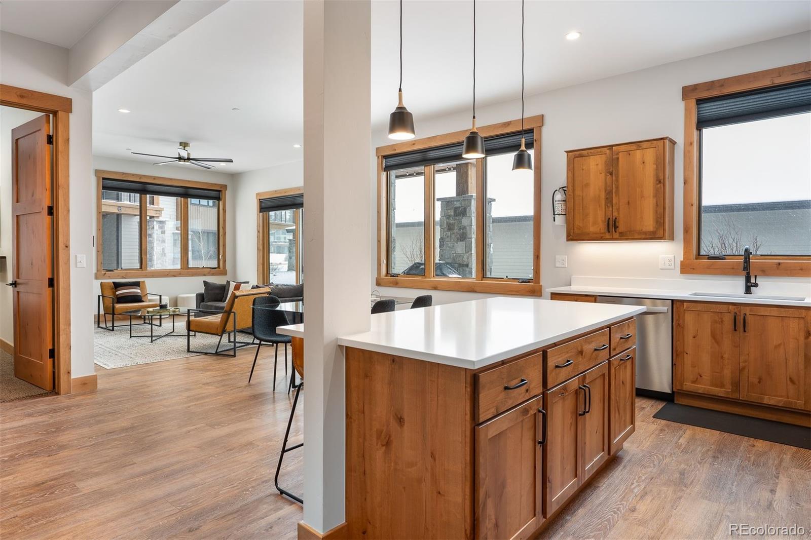 72 Meadow Trail, Unit F102 Fraser, CO 80442 - Photo 8 of 35 a kitchen with stainless steel appliances granite countertop a sink a stove and a wooden floors
