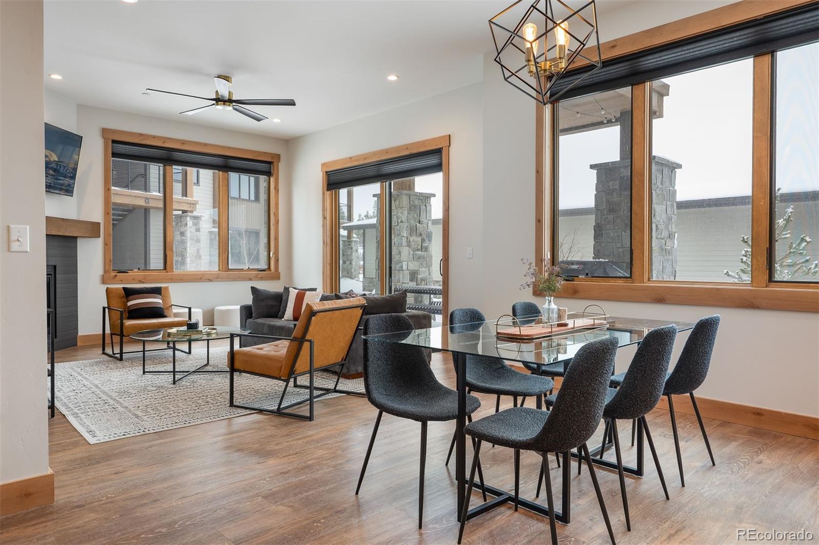 72 Meadow Trail, Unit F102 Fraser, CO 80442 - Photo 9 of 35 a view of a dining room with furniture large windows and wooden floor