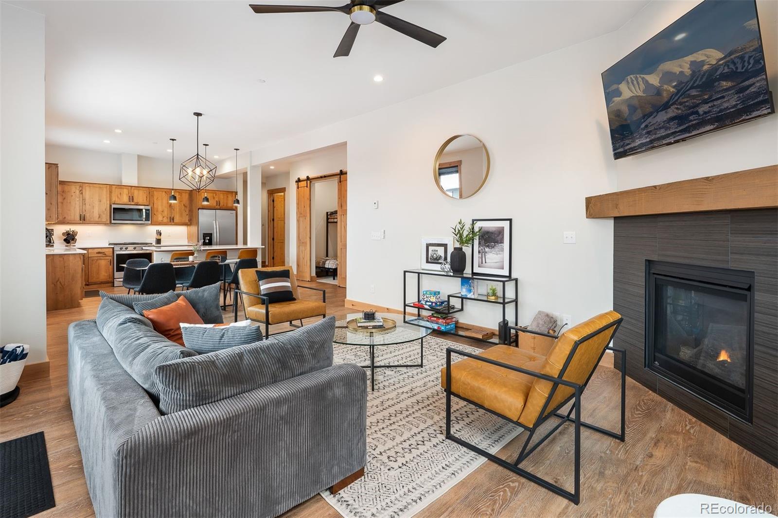 72 Meadow Trail, Unit F102 Fraser, CO 80442 - Photo 10 of 35 a living room with furniture kitchen view and a fireplace