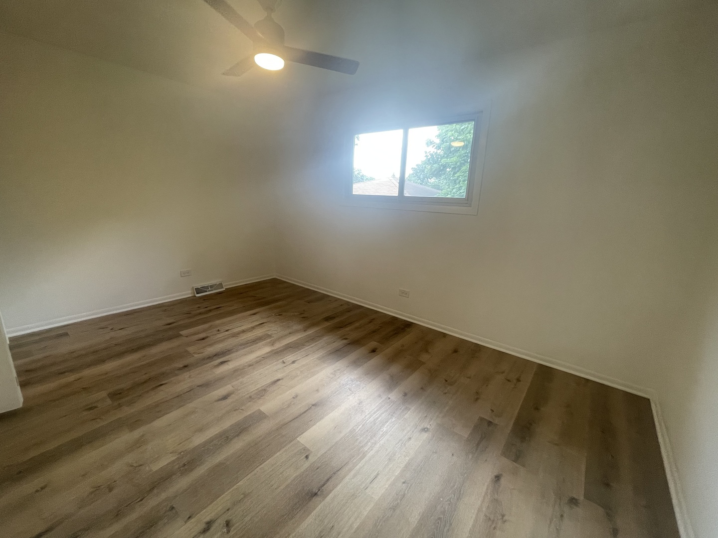 2220 West 158th Street Markham, IL 60426 - Photo 17 of 21 an empty room with wooden floor and windows