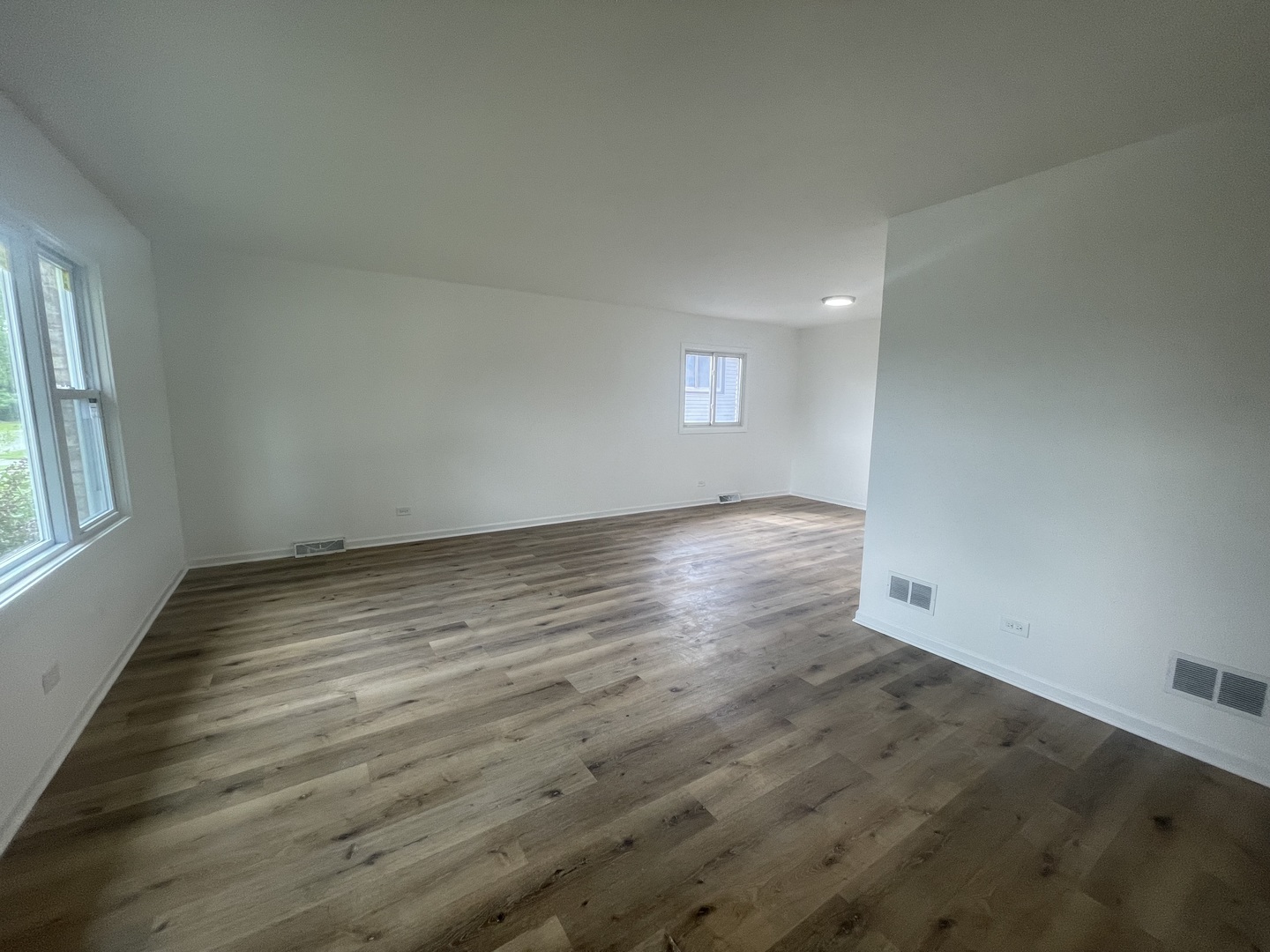 2220 West 158th Street Markham, IL 60426 - Photo 4 of 21 an empty room with wooden floor and windows