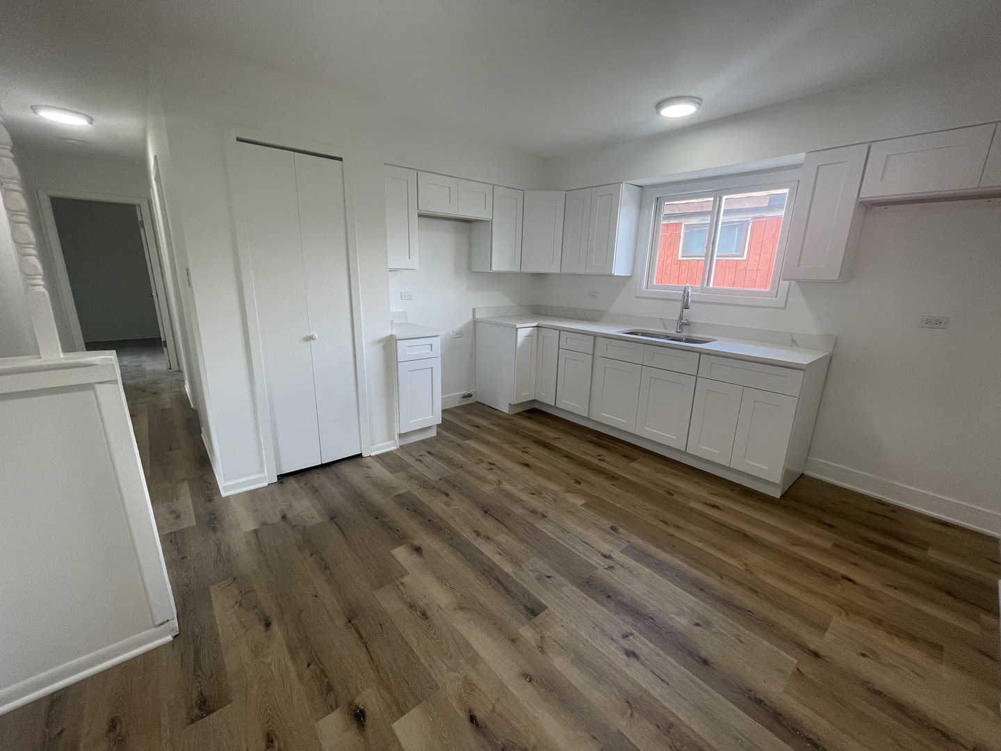 2220 West 158th Street Markham, IL 60426 - Photo 8 of 21 a room with a wooden floor and cabinets