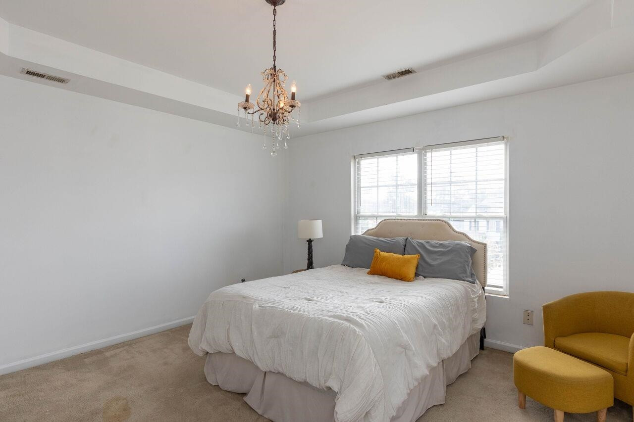 3409 Colossae Court Raleigh, NC 27610 - Photo 15 of 28 a bedroom with a bed and ceiling fan