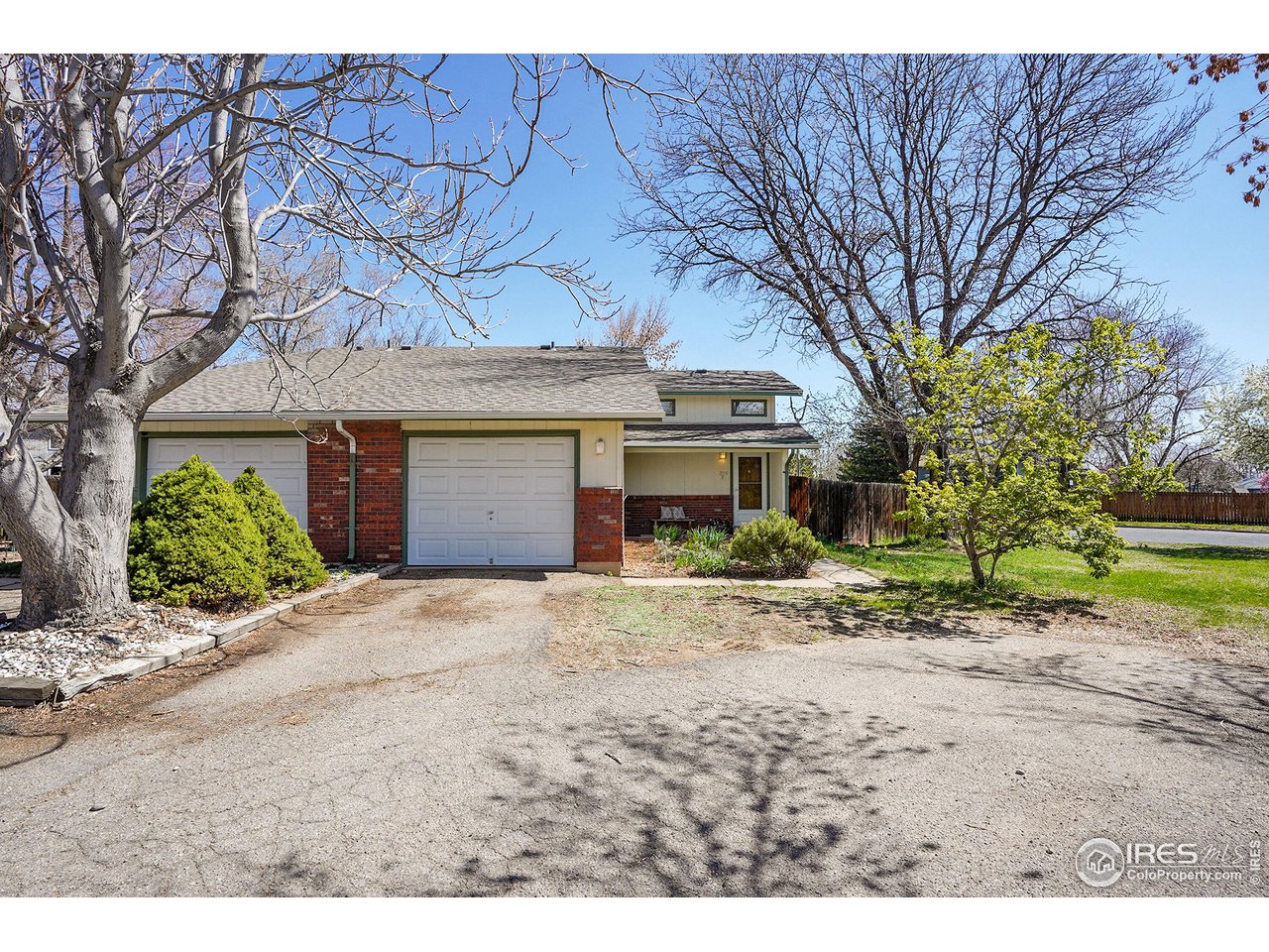 a front view of a house with a yard and a garage