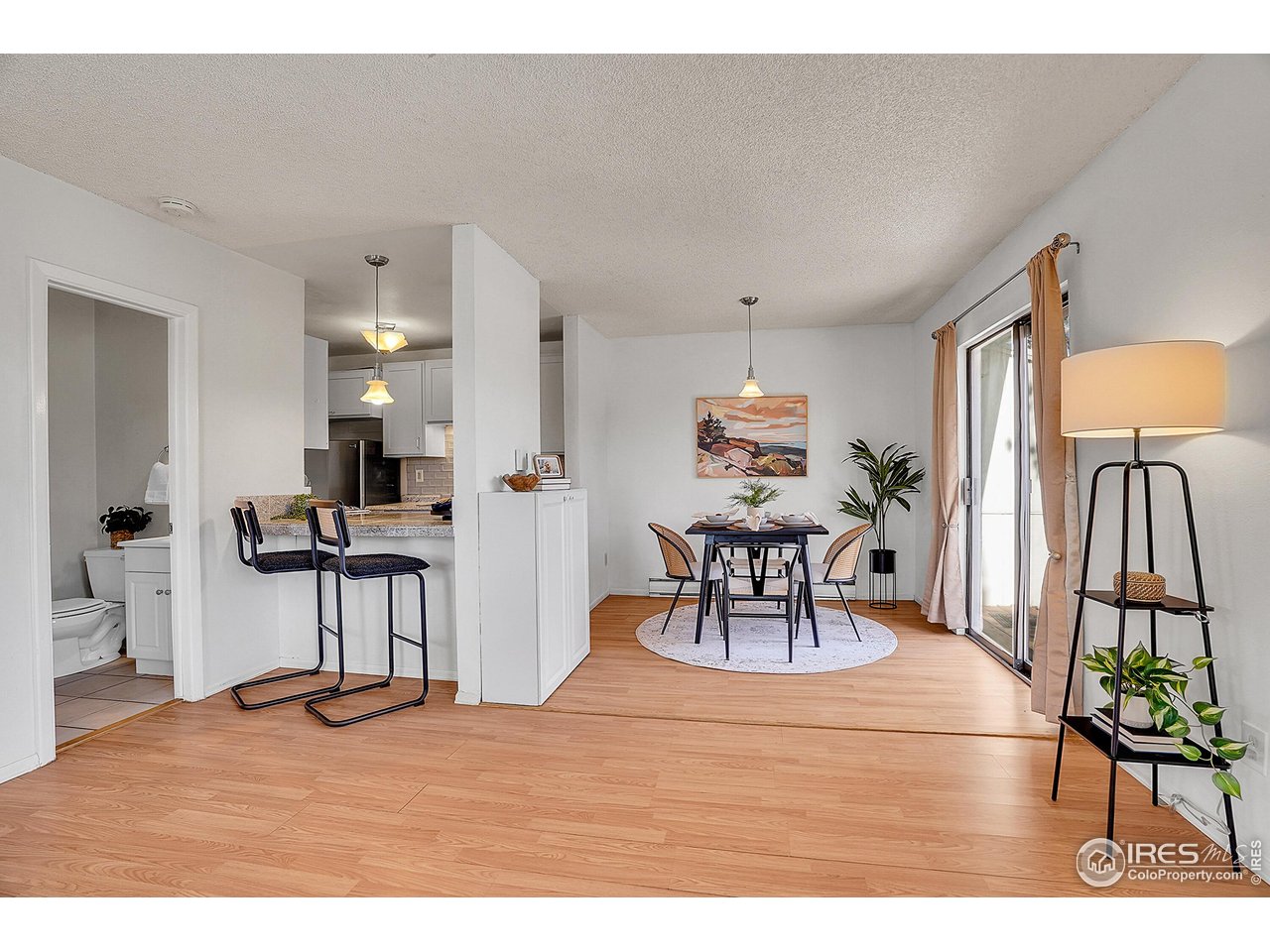 1209 Centaur Circle, Unit B Lafayette, CO 80026 - Photo 13 of 36 a view of a dining room with furniture and a chandelier
