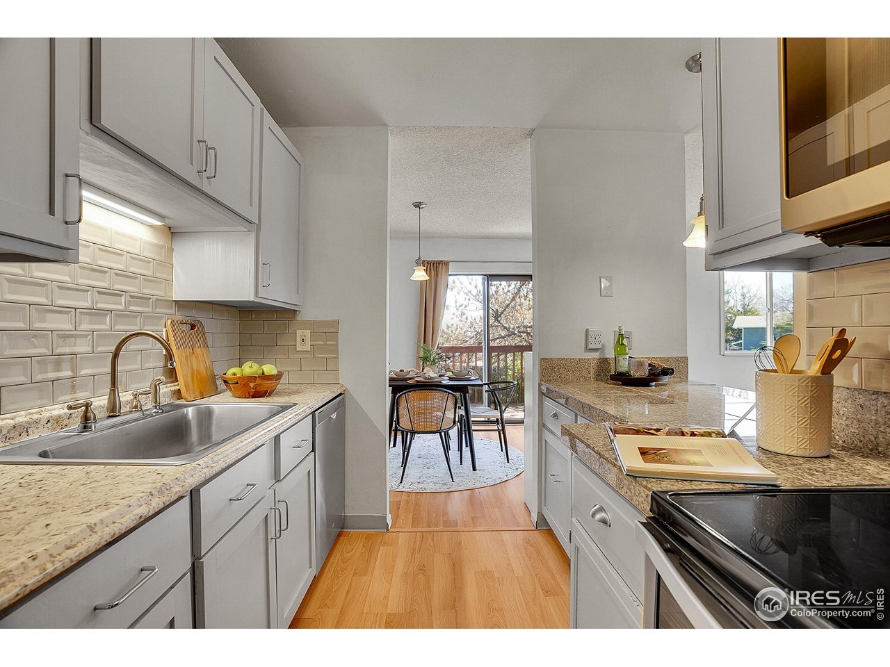 1209 Centaur Circle, Unit B Lafayette, CO 80026 - Photo 16 of 36 a kitchen with stainless steel appliances granite countertop a stove a sink dishwasher and cabinets with wooden floor