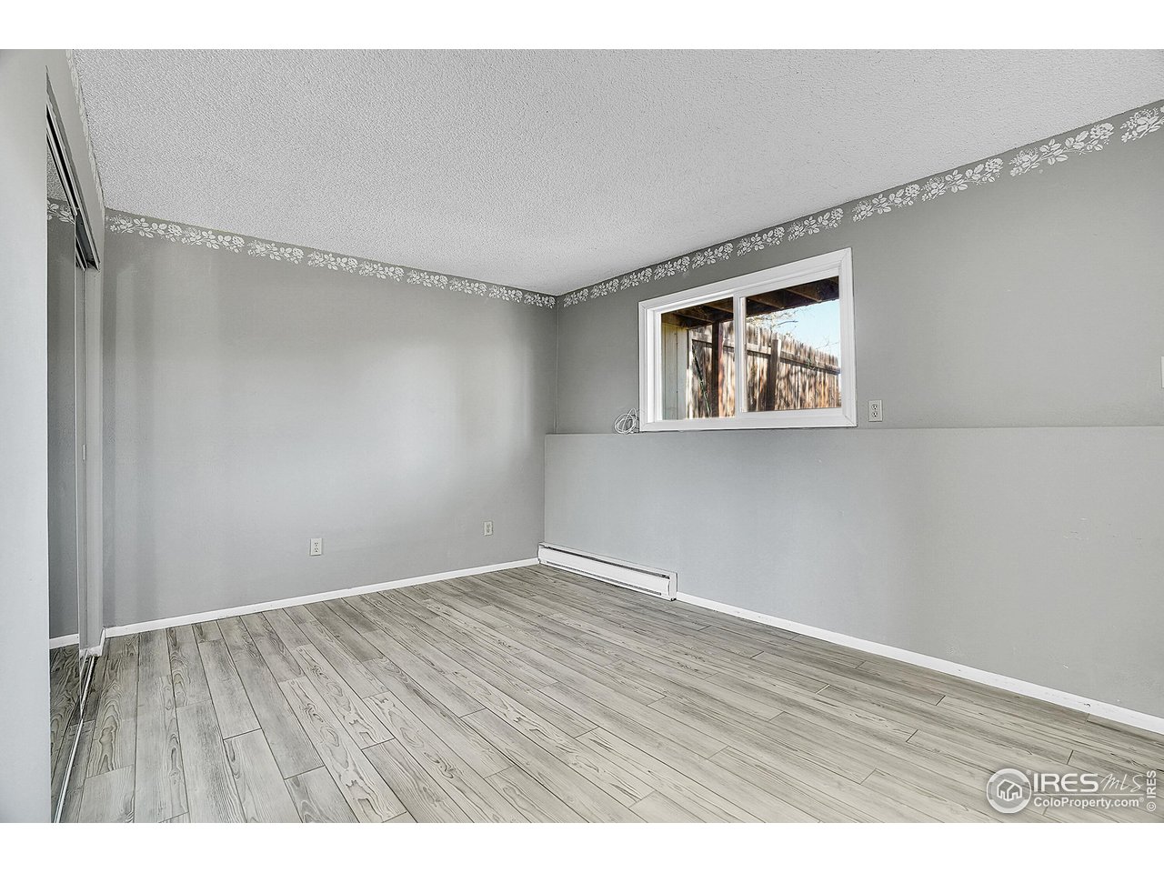 1209 Centaur Circle, Unit B Lafayette, CO 80026 - Photo 19 of 36 a view of an empty room with wooden floor and a window