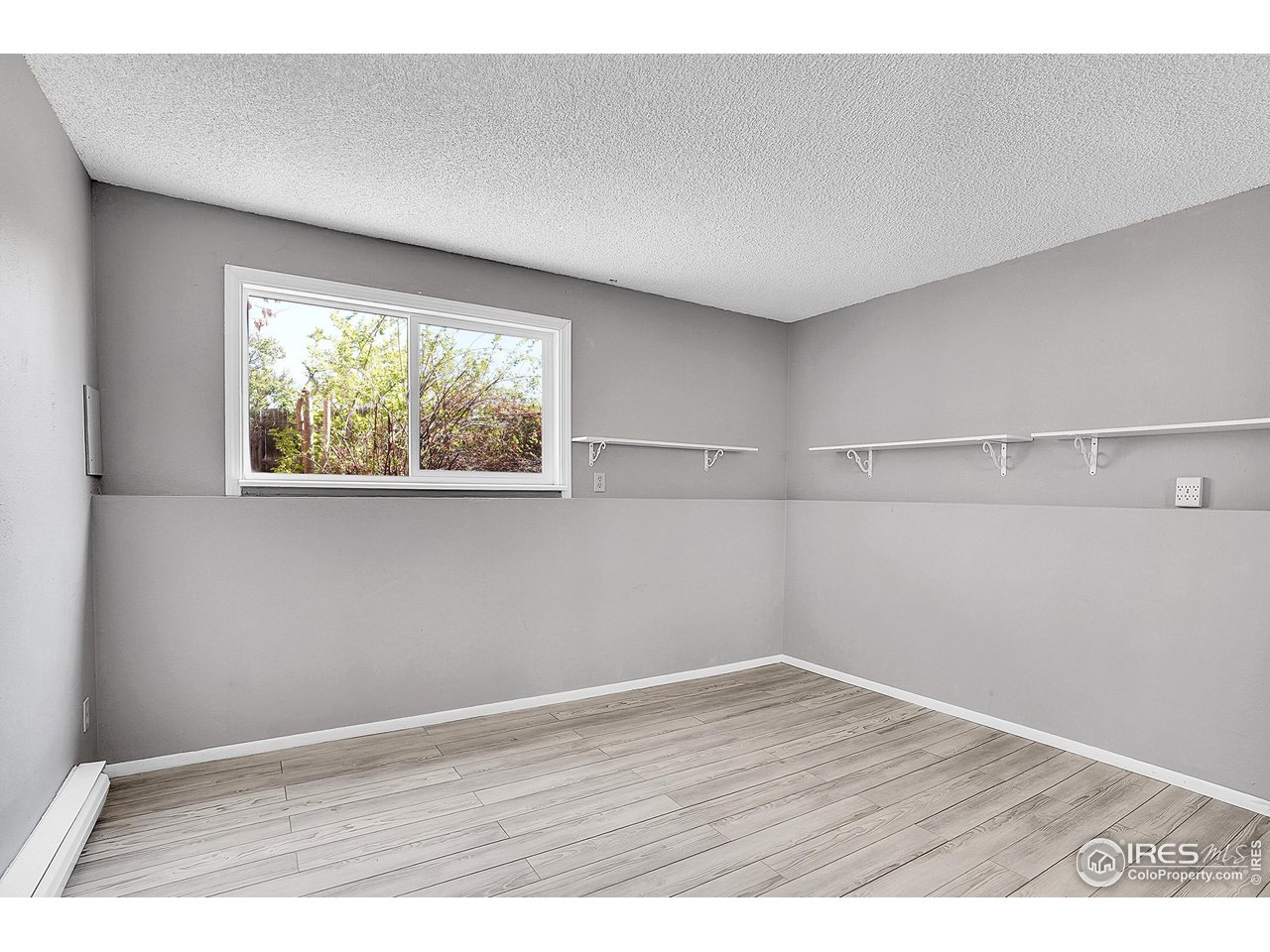 1209 Centaur Circle, Unit B Lafayette, CO 80026 - Photo 21 of 36 an empty room with wooden floor and windows