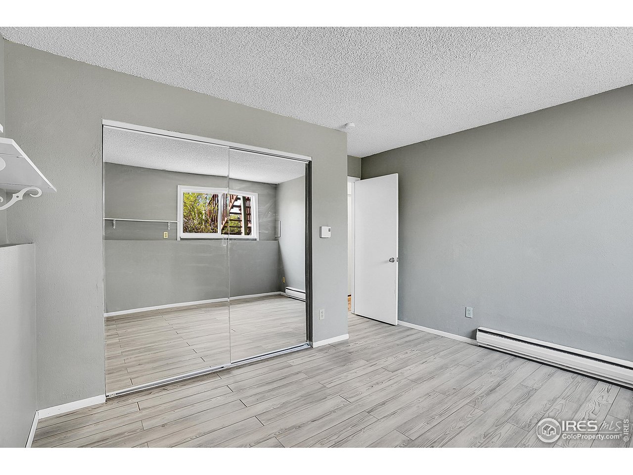 1209 Centaur Circle, Unit B Lafayette, CO 80026 - Photo 22 of 36 a view of an empty room with wooden floor and a window