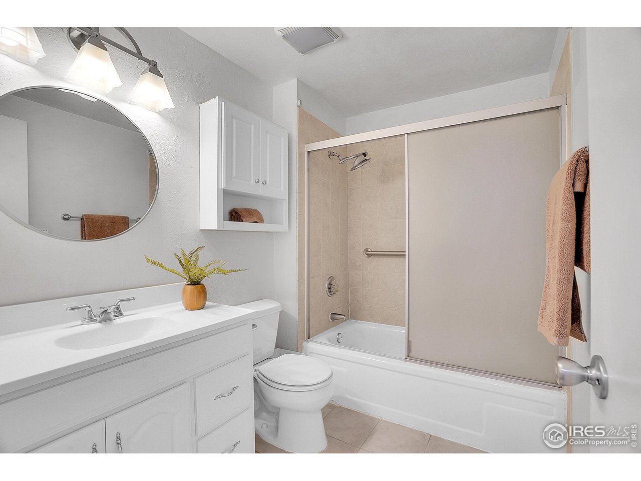 1209 Centaur Circle, Unit B Lafayette, CO 80026 - Photo 24 of 36 a bathroom with a sink a toilet and shower